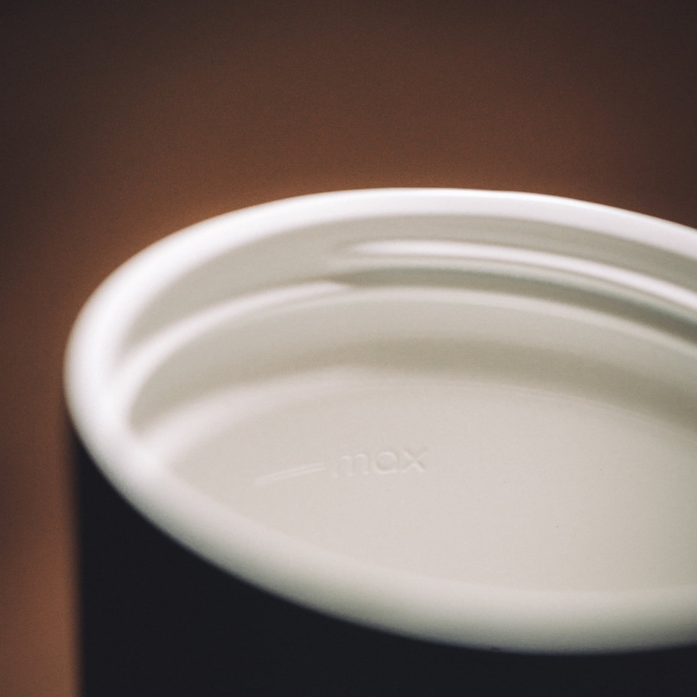 Ceramic lined block: Close-up looking inside a bru travel mug showing the white ceramic-lined interior coating
