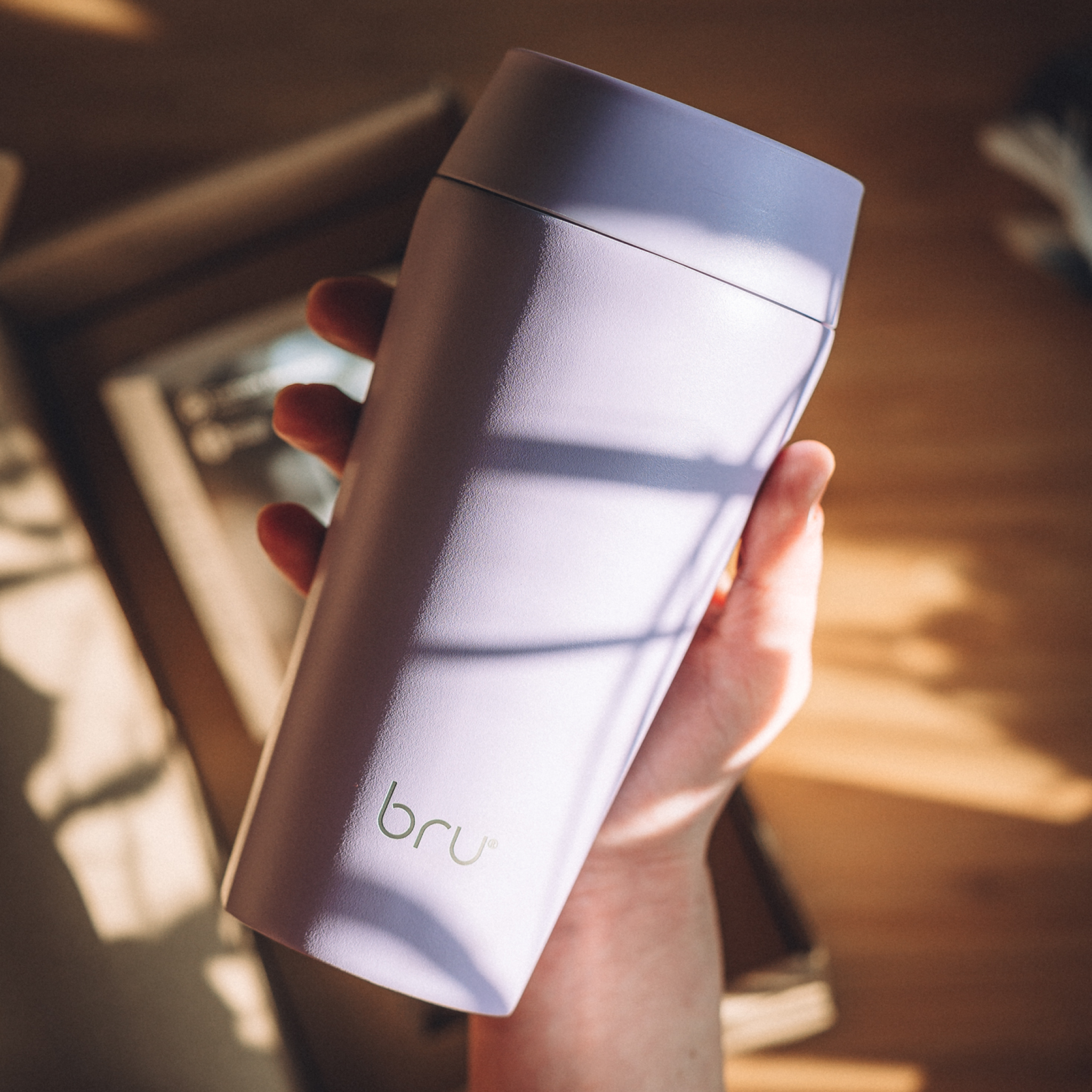 hand holding bru ceramic travel mug in purple dream
