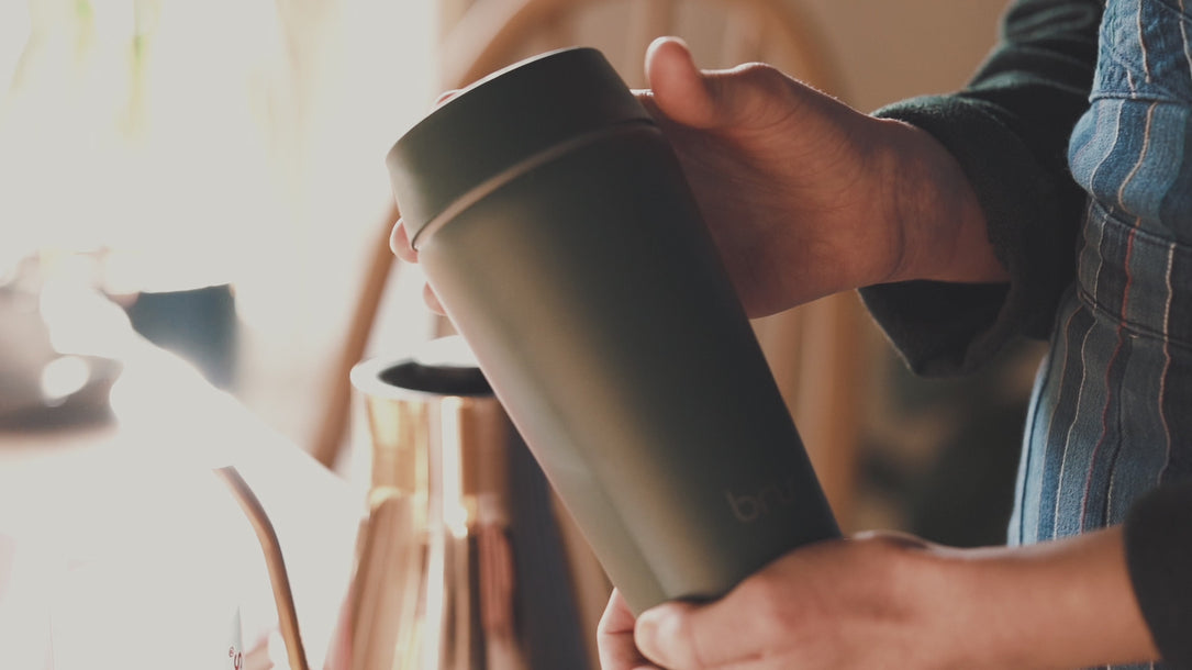 bru ceramic travel mug shown in use in different settings, including with an AeroPress at home and in a car