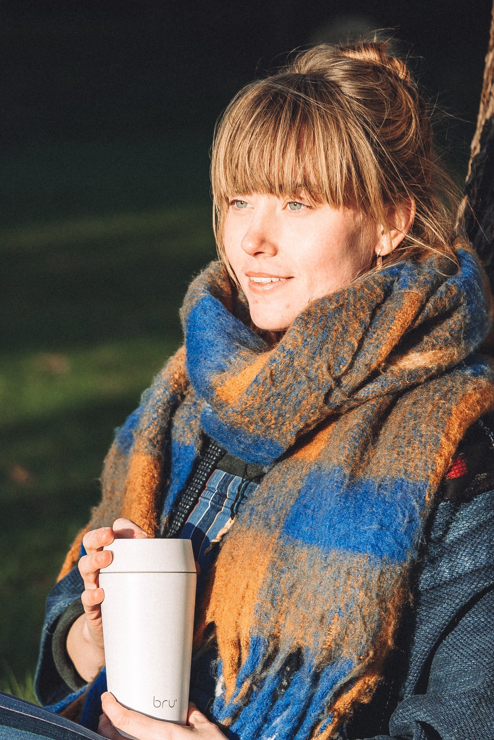 Bru-Cups ceramic-lined travel mug, white, being held by person outdoors